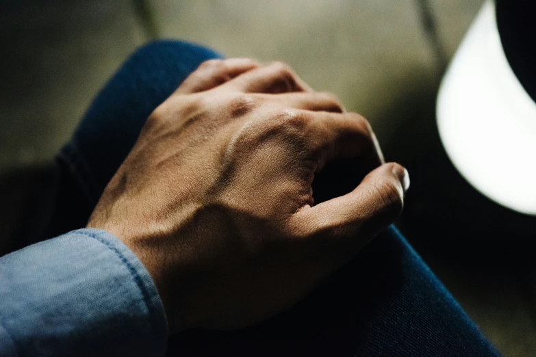 a person holding their hand over the seat of a car