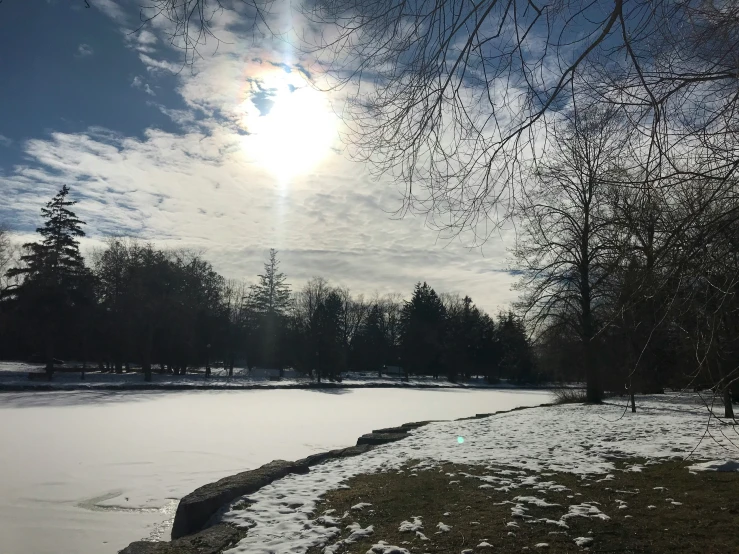 a body of water with snow on the ground