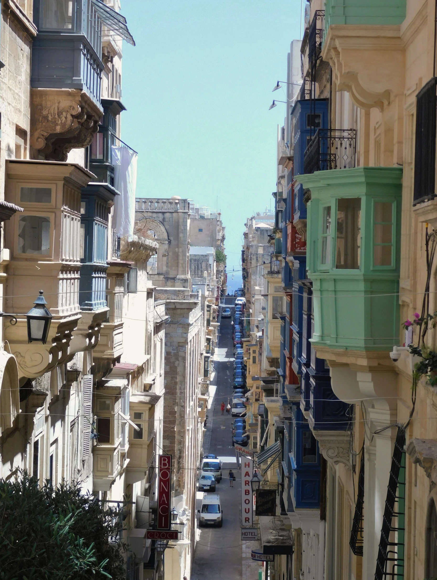 a narrow city street with old, stone buildings