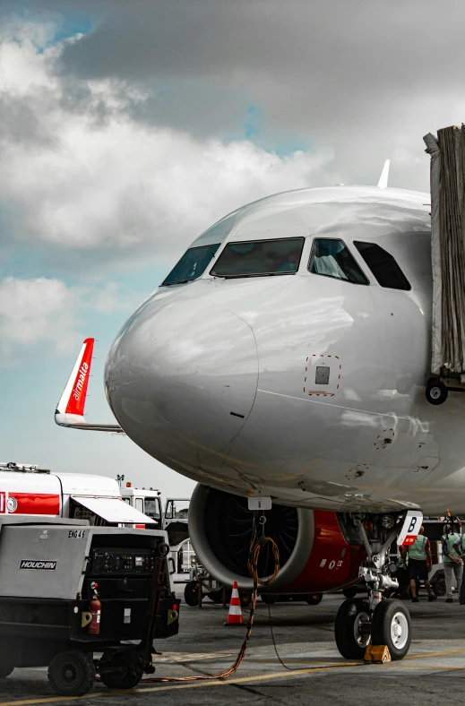 a jet is being loaded with luggage at an airport