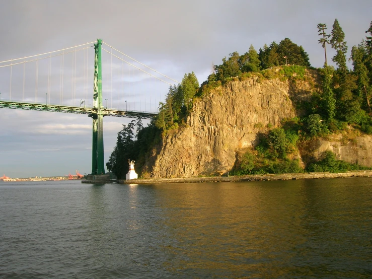 the bridge is above the water near the shore