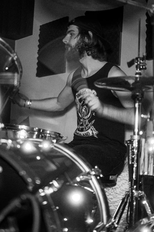 a girl playing drums in black and white po