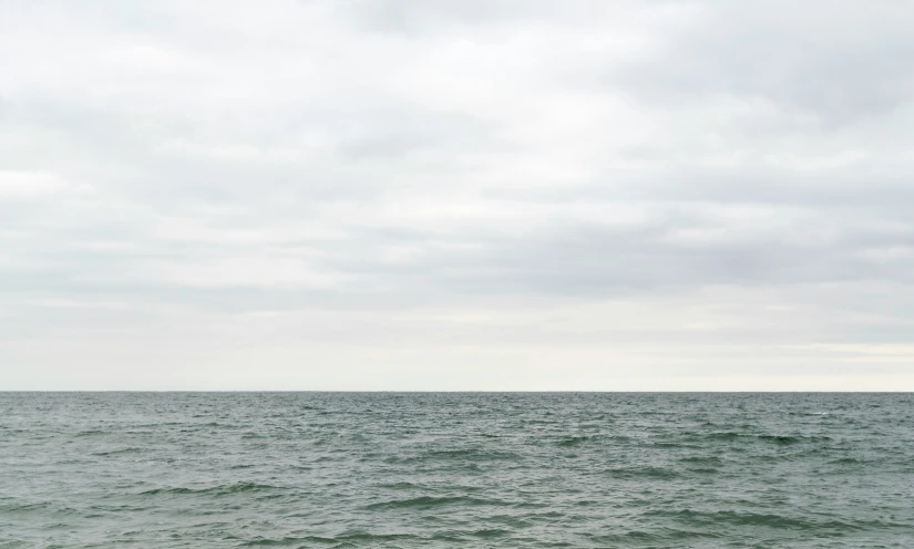 a boat is sitting on top of the ocean