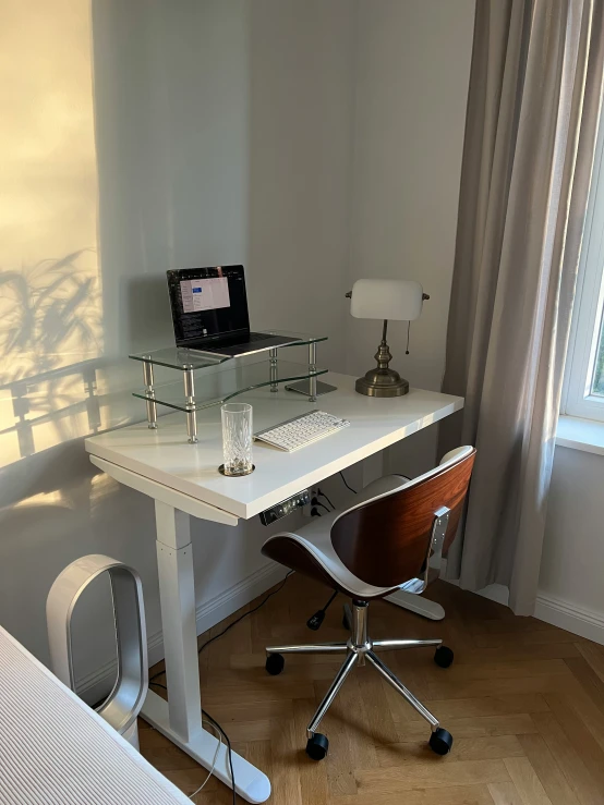 a desk with three shelves that are holding computer equipment