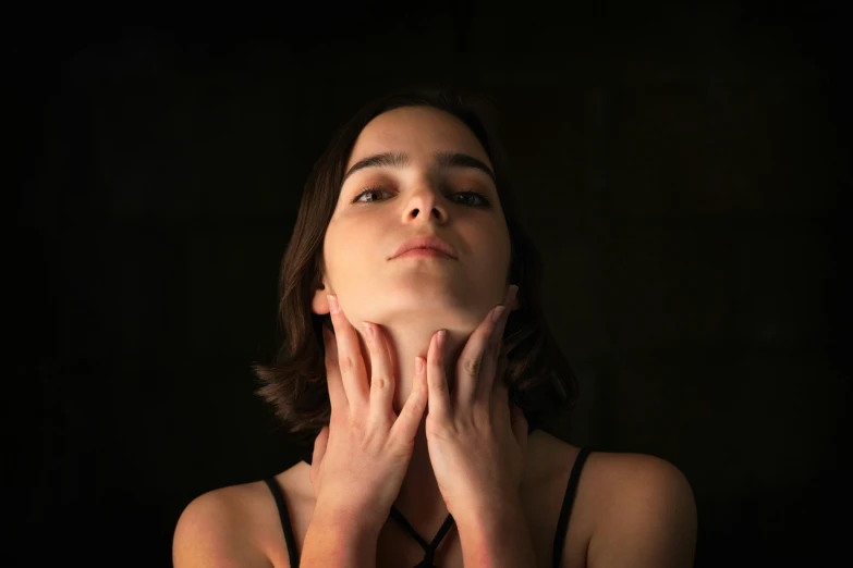 a woman in a black tank top praying