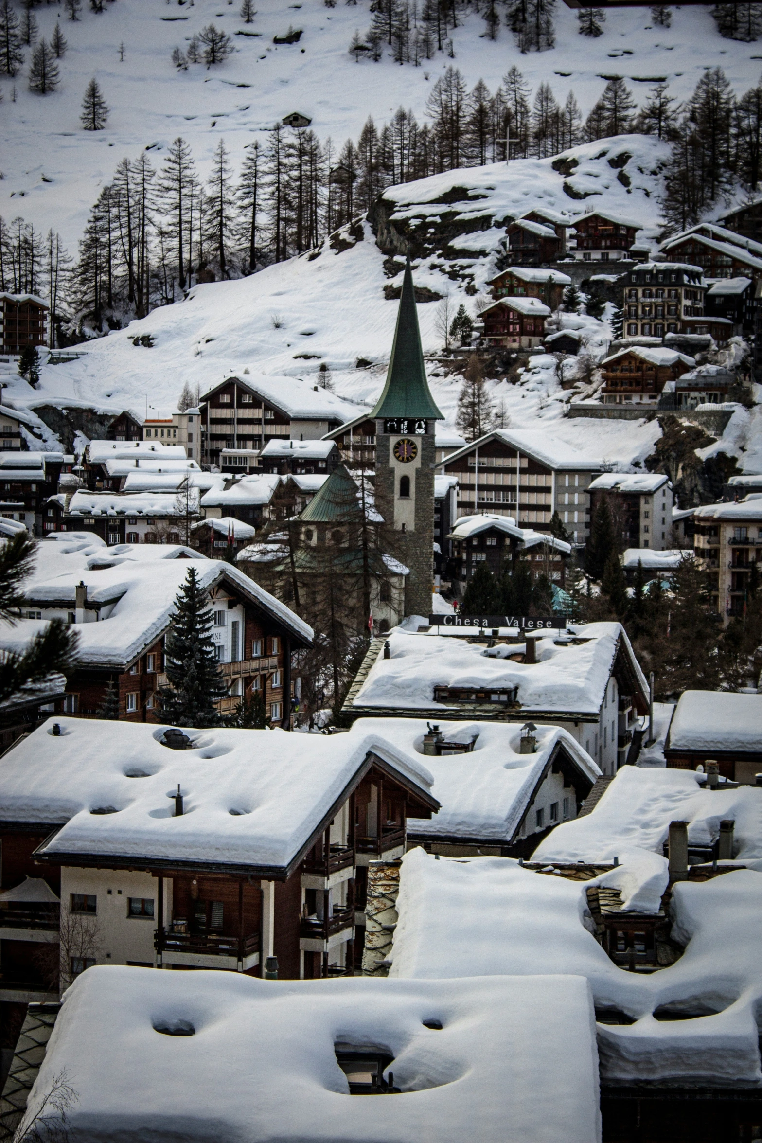 a snowy view of snow covered towns on a hillside