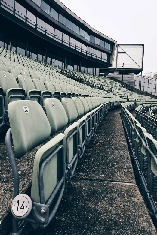 rows of empty seats sit on a field