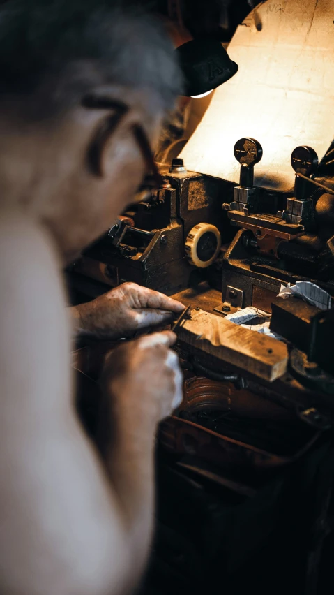 a man using a hand drill and woodworking tool