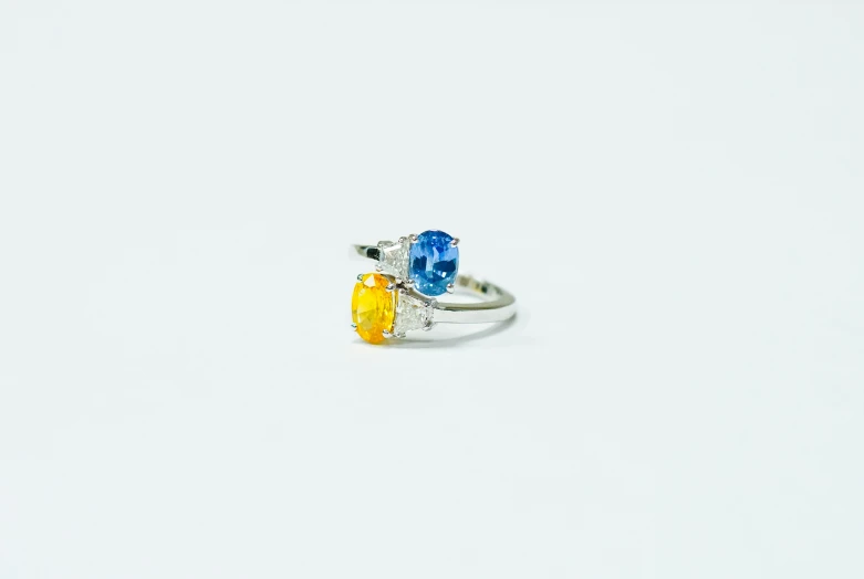 two ring styles, each with one light blue and one yellow stone