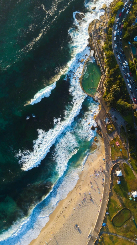 an aerial view of the coast next to an ocean