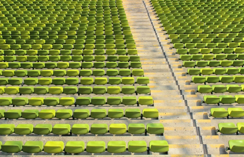 rows of chairs in an empty stadium with yellow edges