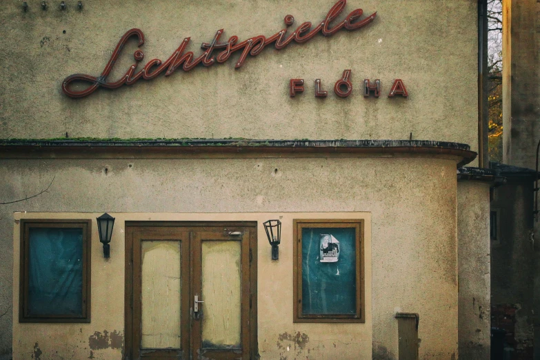 a building with two doorways sitting next to a sidewalk