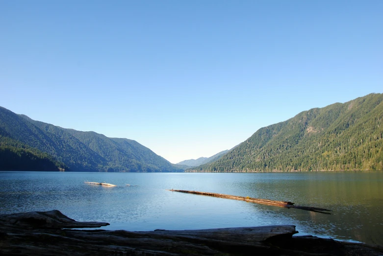 an image of the ocean and mountains with a boat in the water