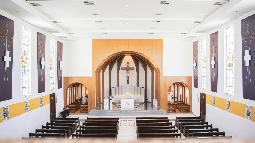 a church with stained glass windows and wooden pews