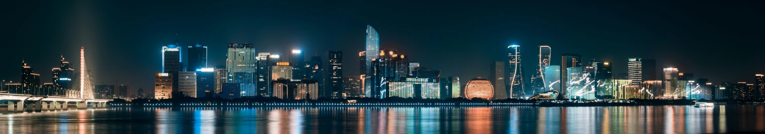 a city at night reflected in the water