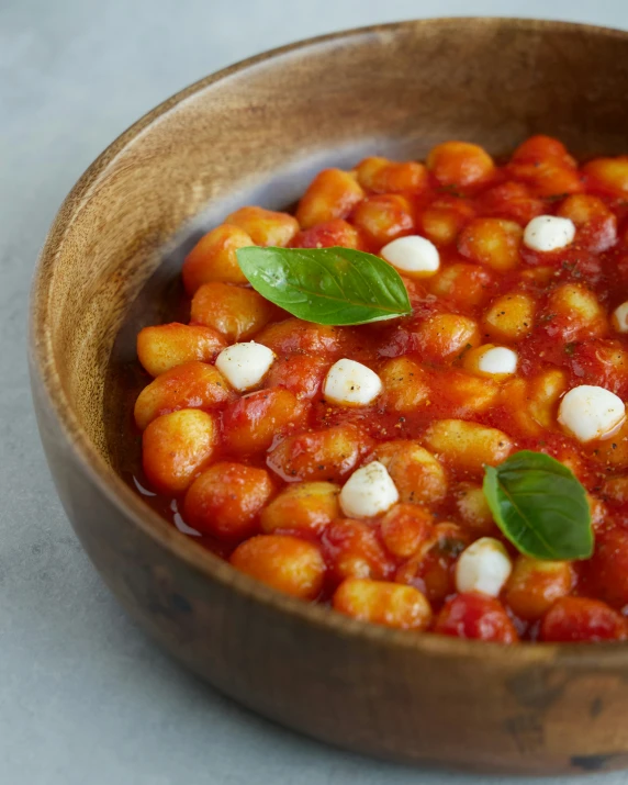 some food in a brown bowl on a table