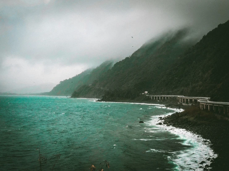 some dark water and mountains near the shore