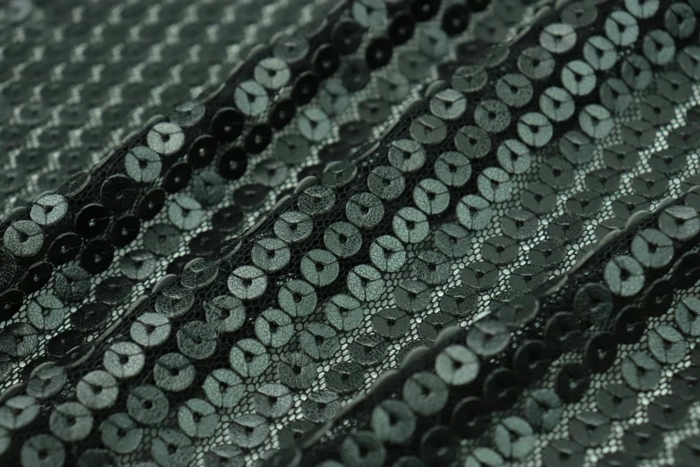 closeup of black and grey lace with black circles