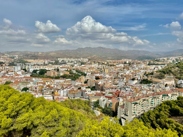 the view over the city from atop of a hill