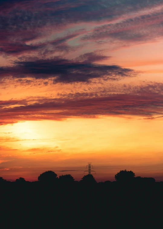 an airplane flying in the sunset