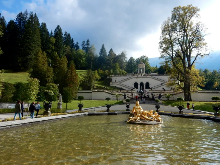 water feature in park with trees and building in background