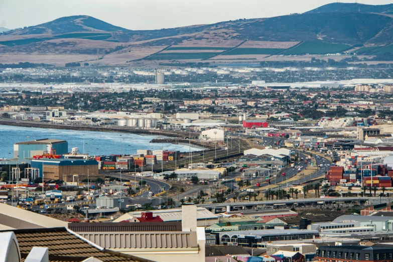 a city is shown with lots of mountains in the background