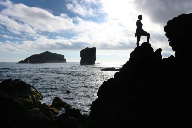 the person is standing on top of a rock