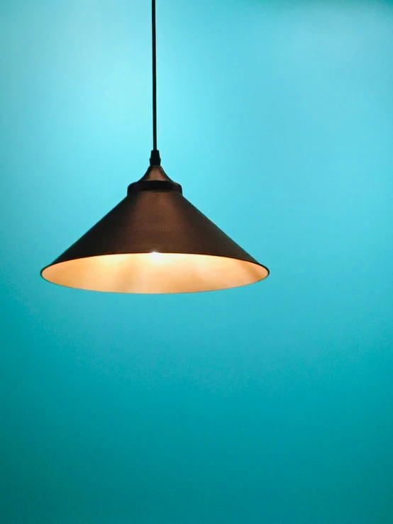 a light hanging from a ceiling in the air
