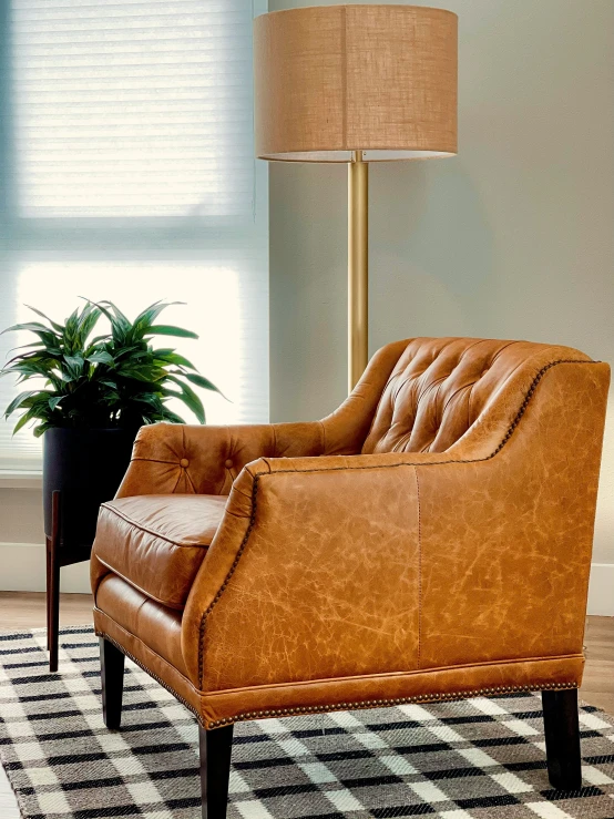 tan leather chair on checkered rug in the living room