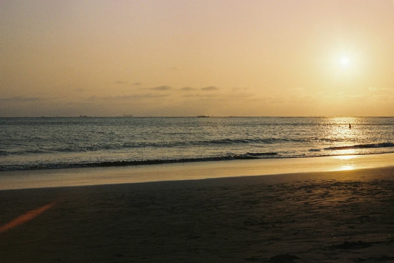 the sunset is shining over a small body of water