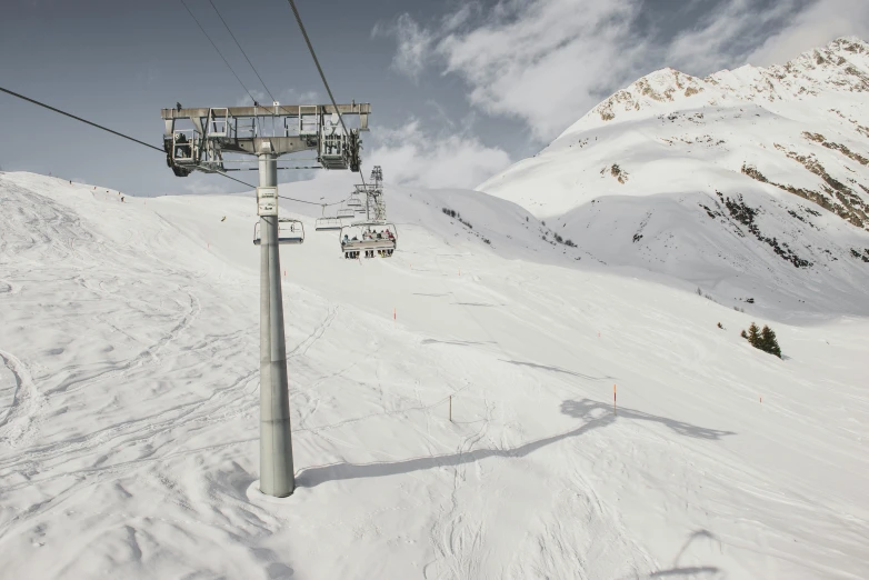 a ski lift with many skiers going down it