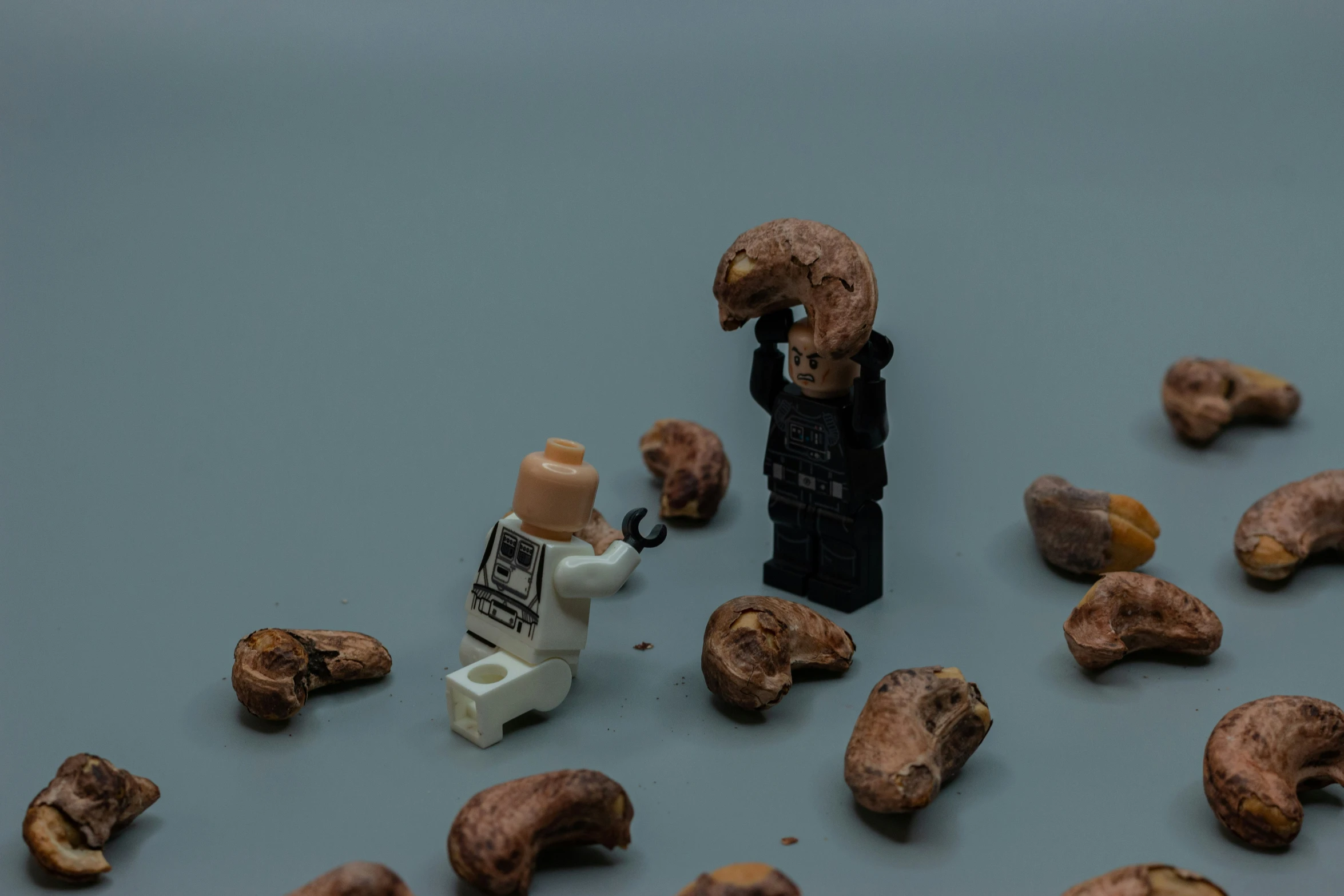 a lego figurine holding an umbrella amongst some chocolate chips