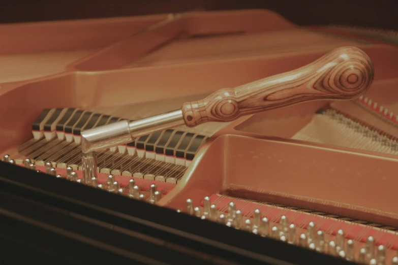 a wooden and metal instrument is in the dark