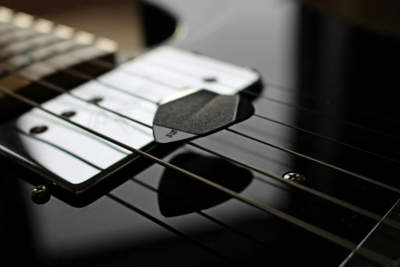 close up on an electric guitar's neck and frets