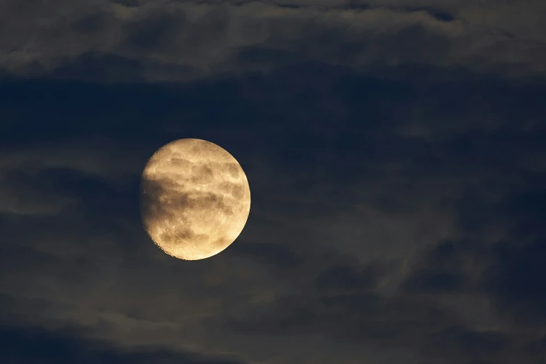 a moon seen from the sky in the clouds