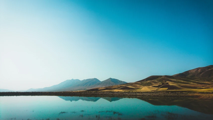 a big body of water sitting on top of a mountain