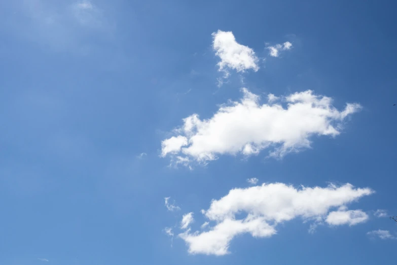 a lone jet is in the blue sky above an airplane