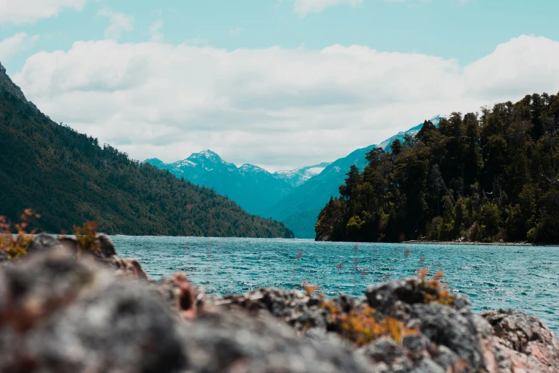 mountains are seen in the background as a body of water sits at the edge