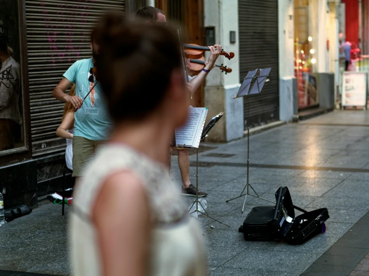 people playing musical instruments on the side of the road