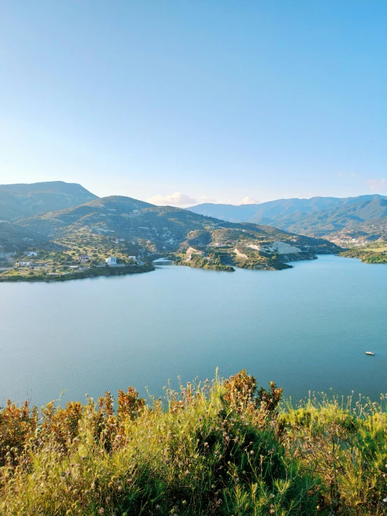 a bench overlooking a large lake and mountains