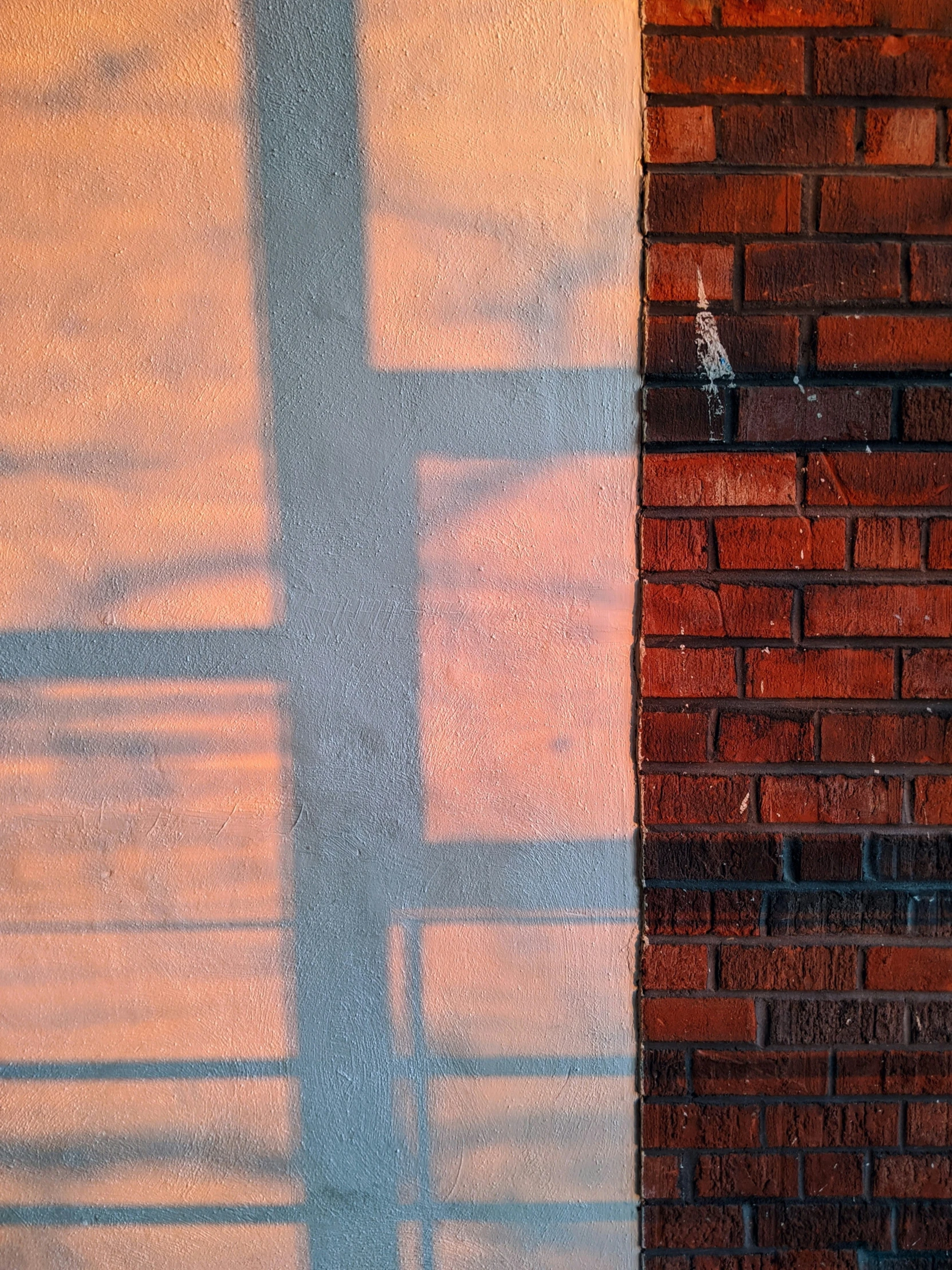 the back and side of a brick wall with a bird perched on it