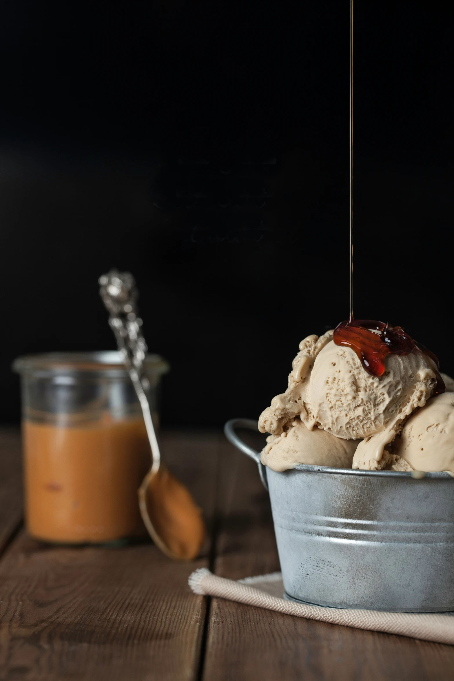 the scoops of ice cream are being poured from a tin