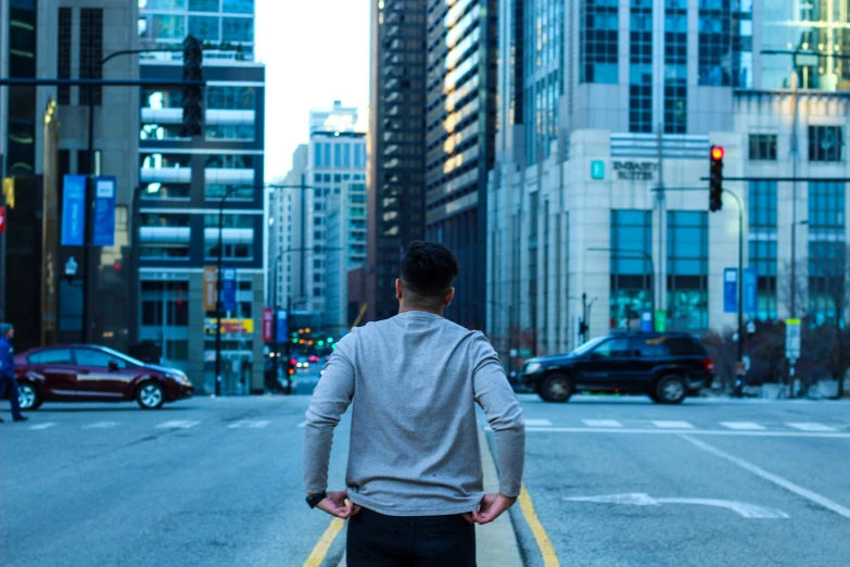 a man walking across an empty city street