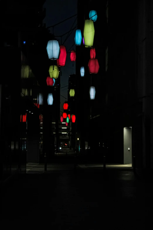 a nighttime scene with lit lanterns shining in the dark