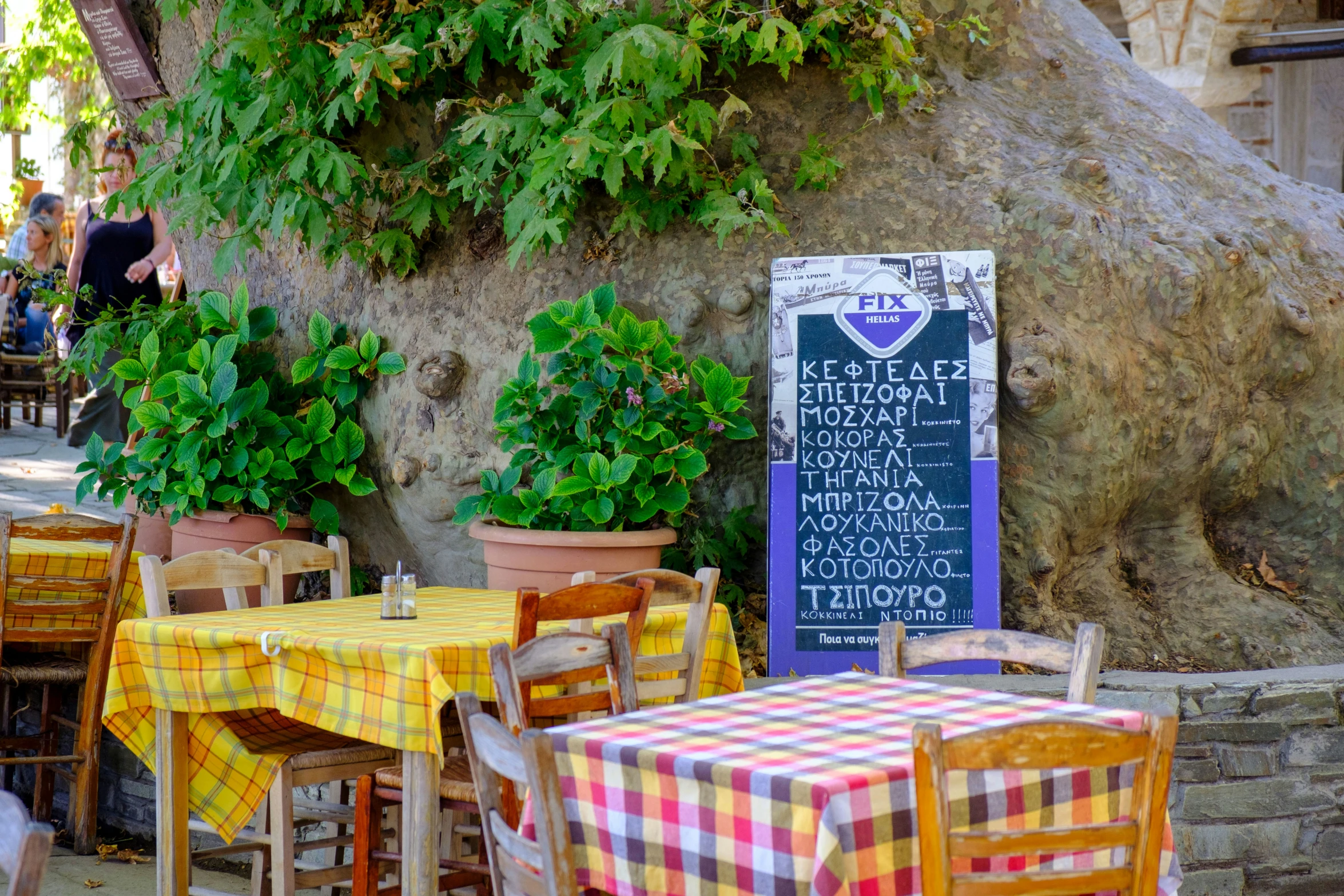 the tables and chairs are decorated with colorful tablecloths