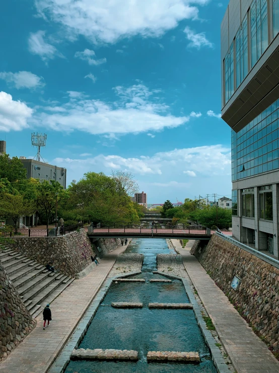 a stone fountain in a park surrounded by tall buildings