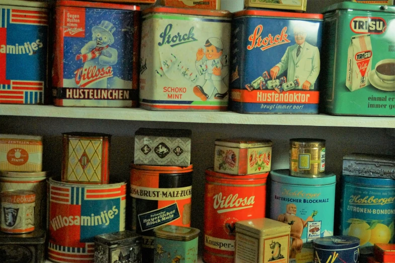 an assortment of retro spice containers line a shelf