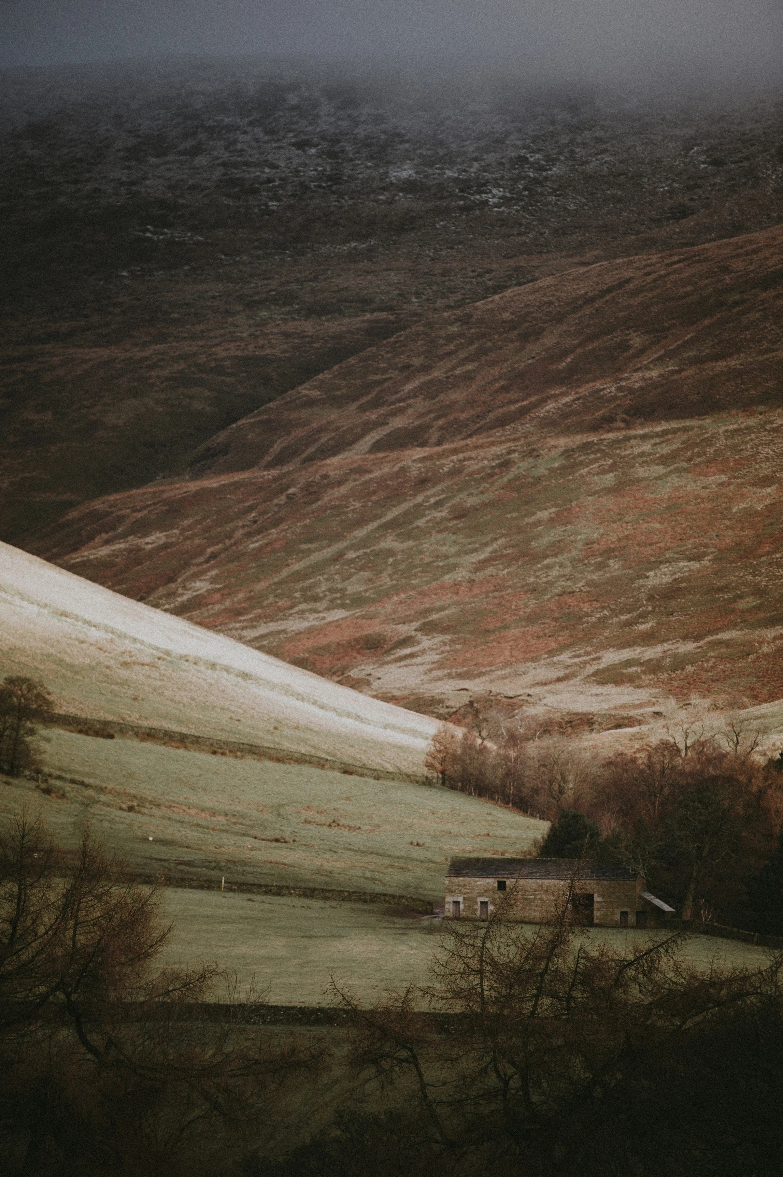 a long way through a wide open valley with hills