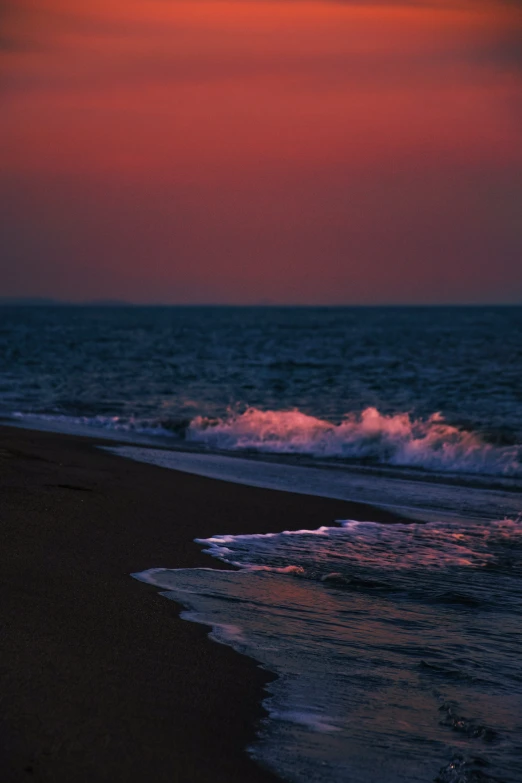 some waves come in and they're hitting the sand