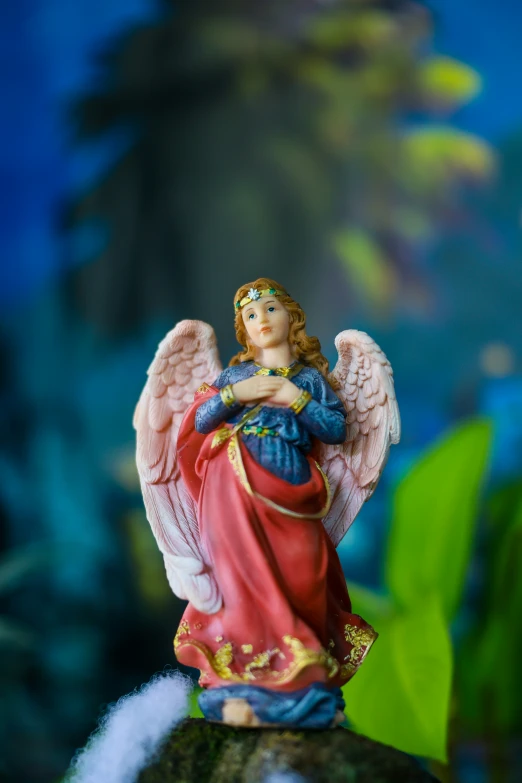 the figurine is of an angel holding a baby jesus